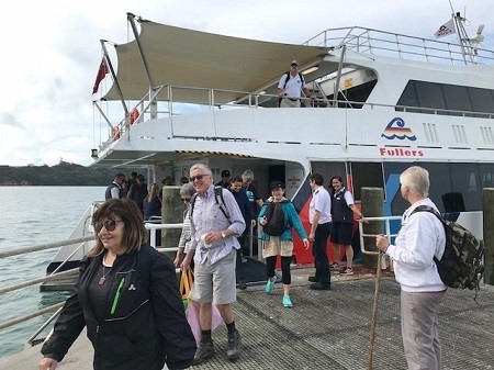 Passengers disembark on to Motuihe wharf from a Fullers ferry